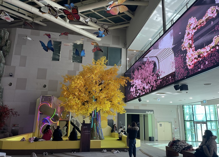 관람객들이 소망나무에서 휴식을 취하고 있다.